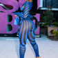 Woman in a blue and black striped outfit by Gsuwoo standing in front of a large 'Sobe' sign.