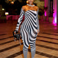 Woman in a zebra-striped outfit  by Gsuwoo standing in a stylishly decorated room with pink lighting.