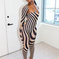 Woman wearing a zebra print outfit by Gsuwoo in a room with a white door and window.