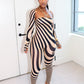 Woman wearing a zebra-striped outfit by Gsuwoo in a minimalistic room.
