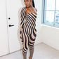 Woman wearing a zebra print outfit  by Gsuwoo in a room with white walls and a window.