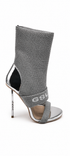 Silver high-heeled shoe with a unique design on a white background